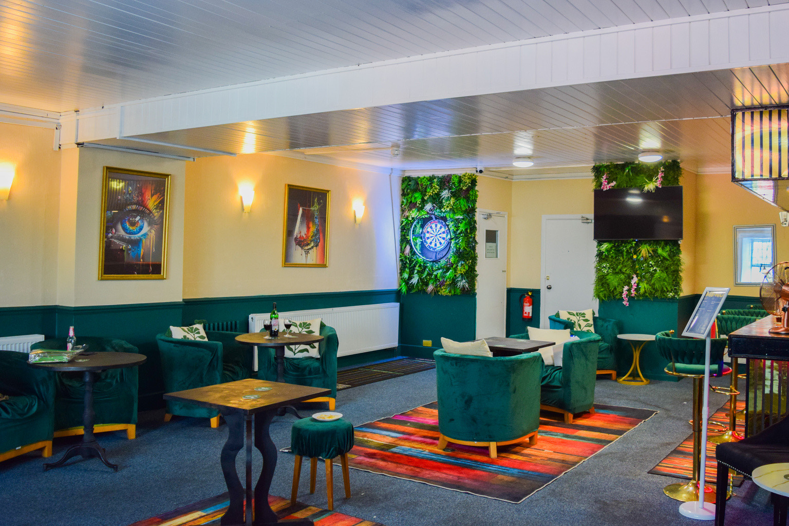 The step-free bar lounge at Ashbury Lounge, with the living wall behind